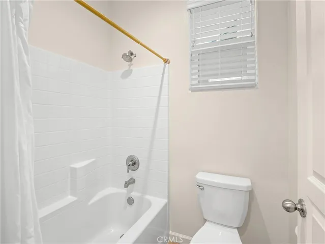 a bathroom with a toilet and a bathtub