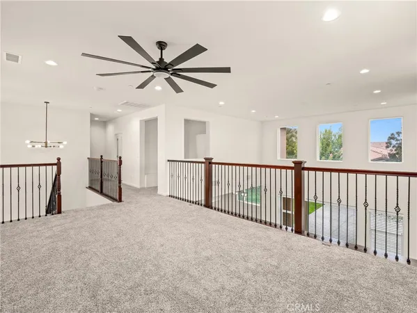 a view of a hallway with a ceiling fan