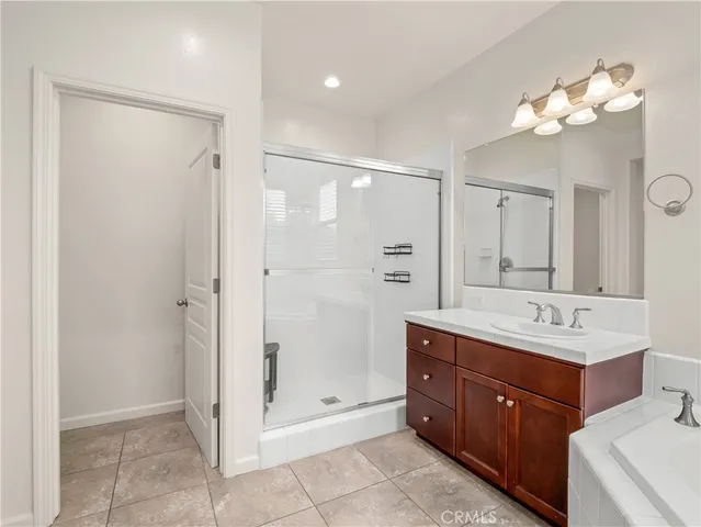 a bathroom with a double vanity sink mirror and shower