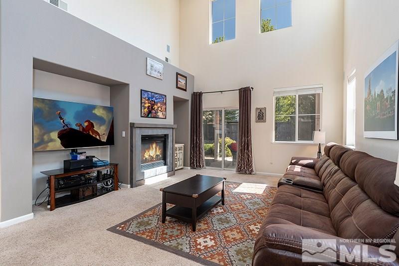 515 Connemaras Court Reno, NV 89521 - Photo 3 of 14 a living room with furniture a flat screen tv and a fireplace