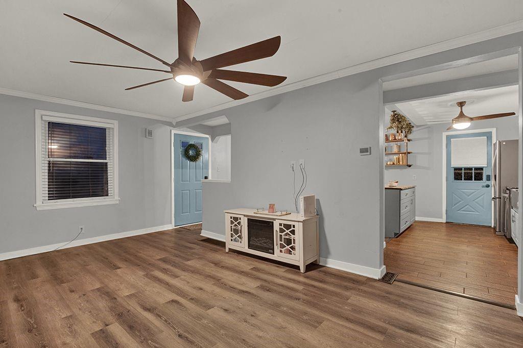 1034 McCoy Road McKees Rocks, PA 15136 - Photo 4 of 22 a view of a livingroom with a ceiling fan and wooden floor