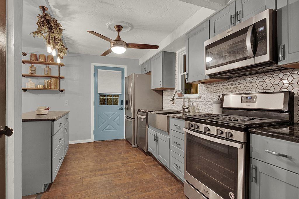 1034 McCoy Road McKees Rocks, PA 15136 - Photo 8 of 22 a kitchen with stainless steel appliances granite countertop a stove cabinets and microwave