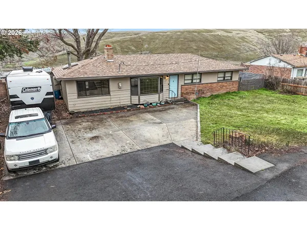 a backyard of a house with table and chairs