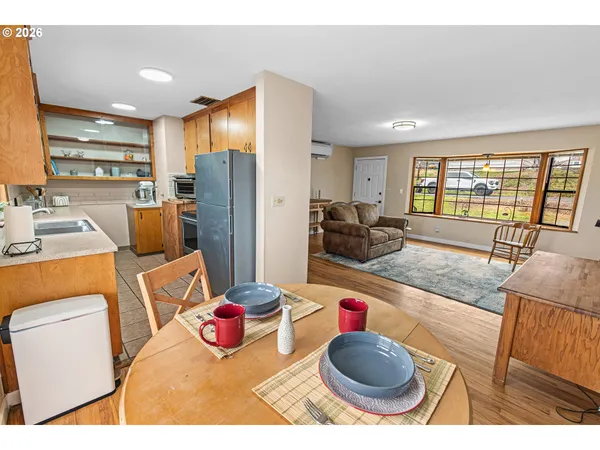 a living room with furniture a rug and a large window