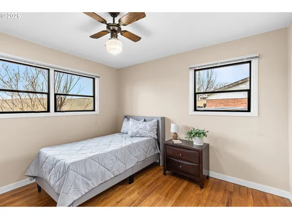 a bedroom with a bed and a painting on the wall