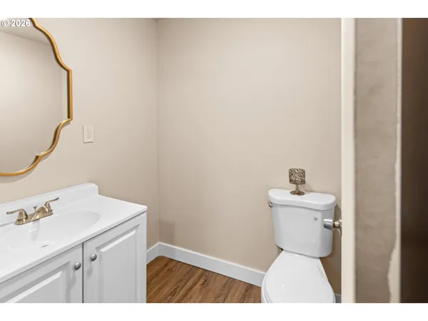 a bathroom with a sink toilet and a mirror