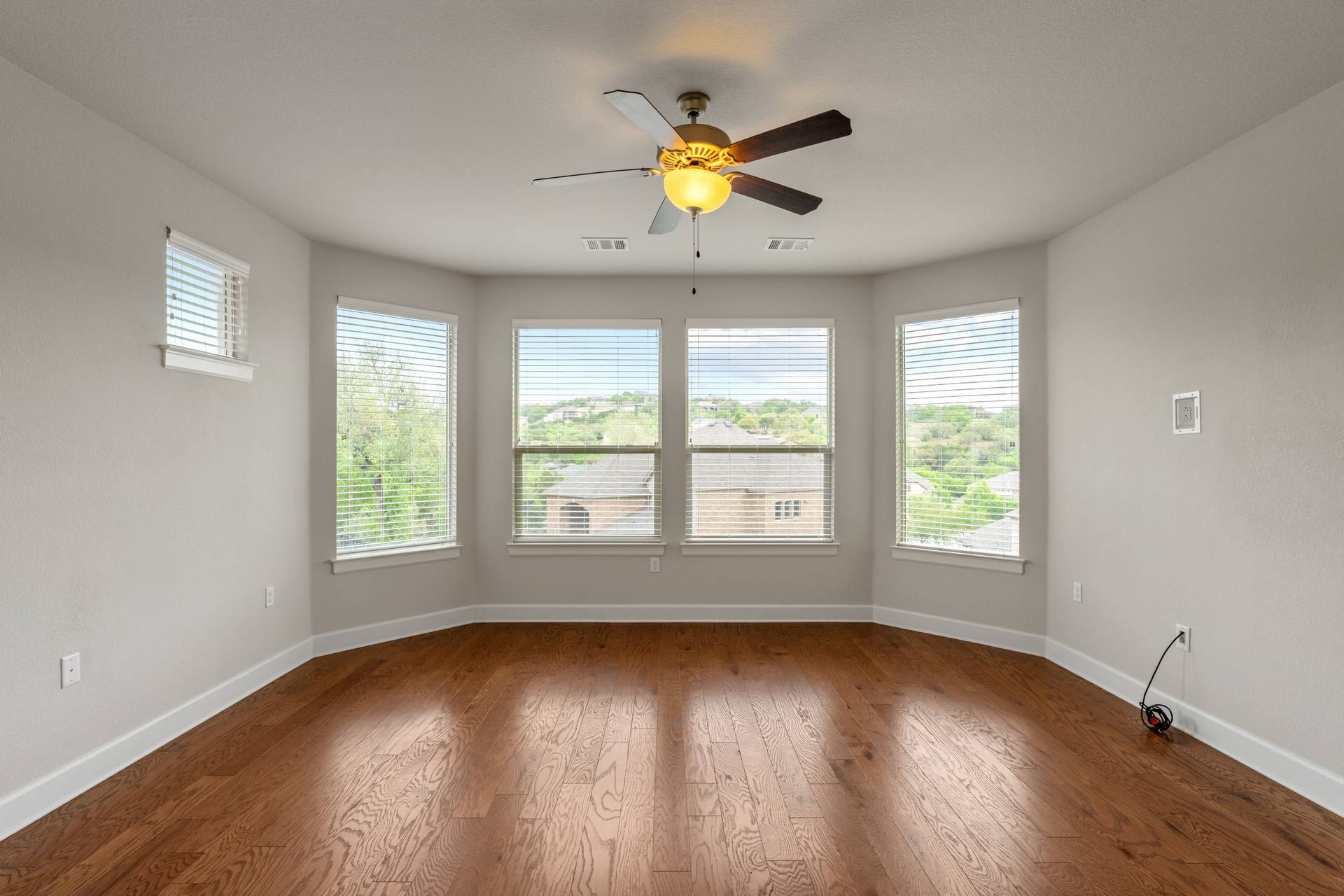3516 Venezia View Leander, TX 78641 - Photo 9 of 40 Empty room with dark wood-style floors and a ceiling fan