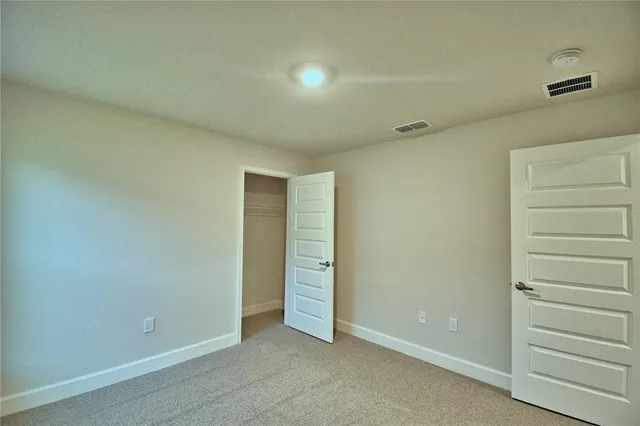 an empty room with walk in closet