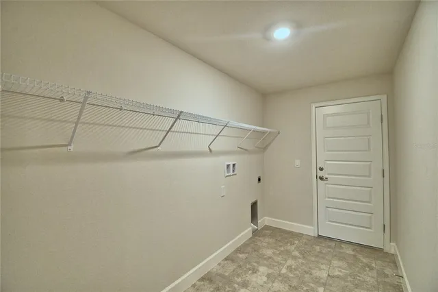 an empty room with closet and natural light