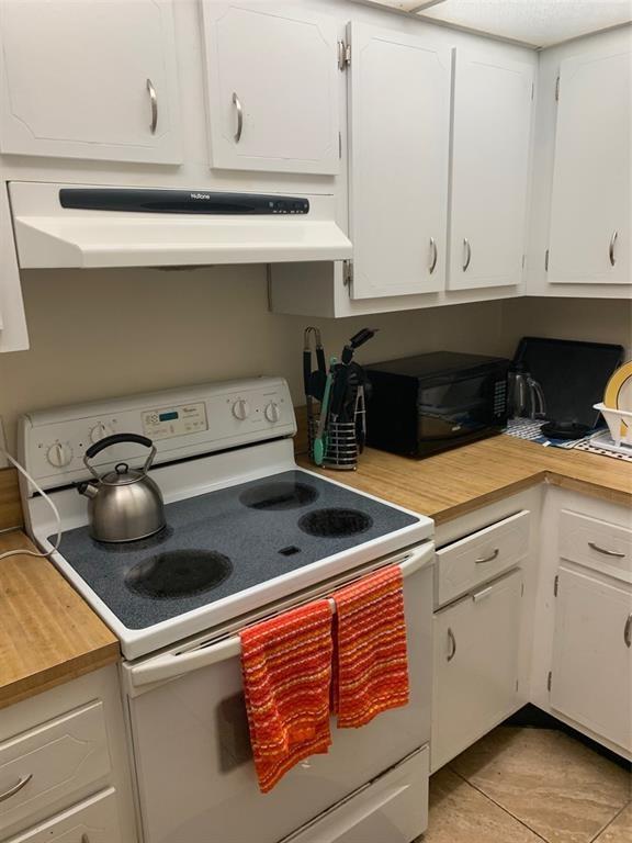 1681 Northwest 70th Avenue, Unit 403 Plantation, FL 33313 - Photo 12 of 54 a kitchen with a stove and cabinets