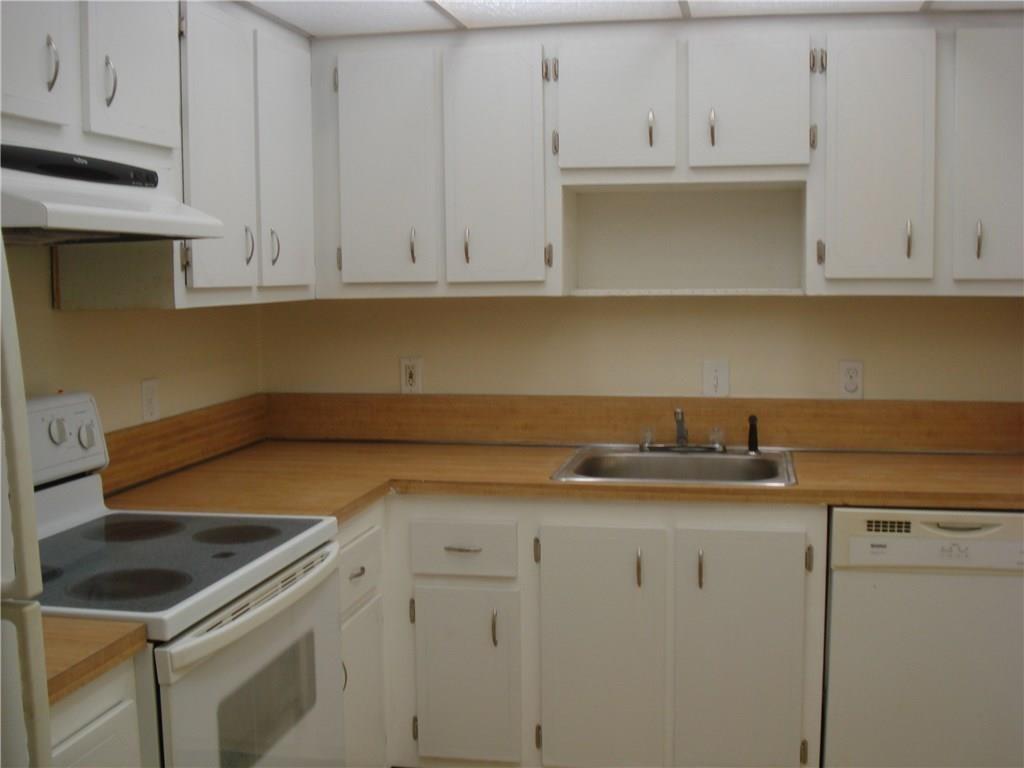 1681 Northwest 70th Avenue, Unit 403 Plantation, FL 33313 - Photo 13 of 54 a kitchen with granite countertop white cabinets and a sink