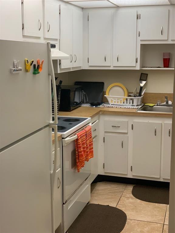 1681 Northwest 70th Avenue, Unit 403 Plantation, FL 33313 - Photo 14 of 54 a kitchen with granite countertop white cabinets and sink