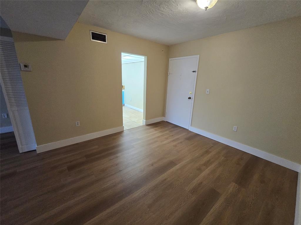 1681 Northwest 70th Avenue, Unit 403 Plantation, FL 33313 - Photo 33 of 54 a view of an empty room with wooden floor