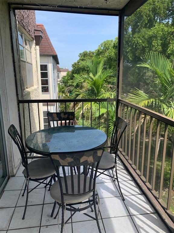 1681 Northwest 70th Avenue, Unit 403 Plantation, FL 33313 - Photo 41 of 54 a view of balcony with furniture and wooden deck