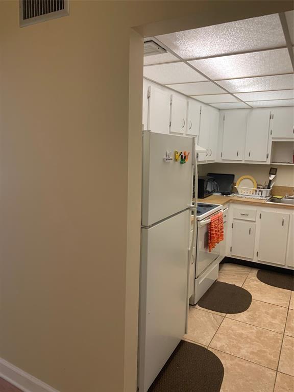 1681 Northwest 70th Avenue, Unit 403 Plantation, FL 33313 - Photo 9 of 54 a white refrigerator freezer sitting inside of a kitchen