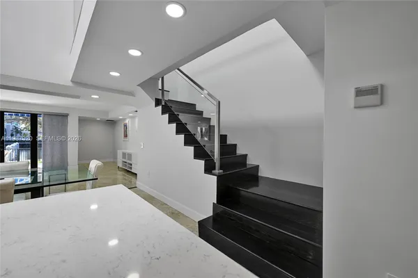 an empty room with windows and ceiling fan