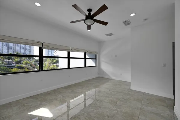a view of swimming pool with outdoor seating and house in the background