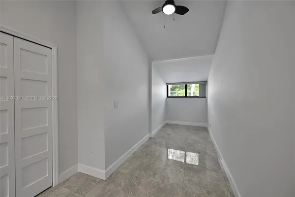 a view of a patio with table and chairs potted plants with wooden floor and large trees