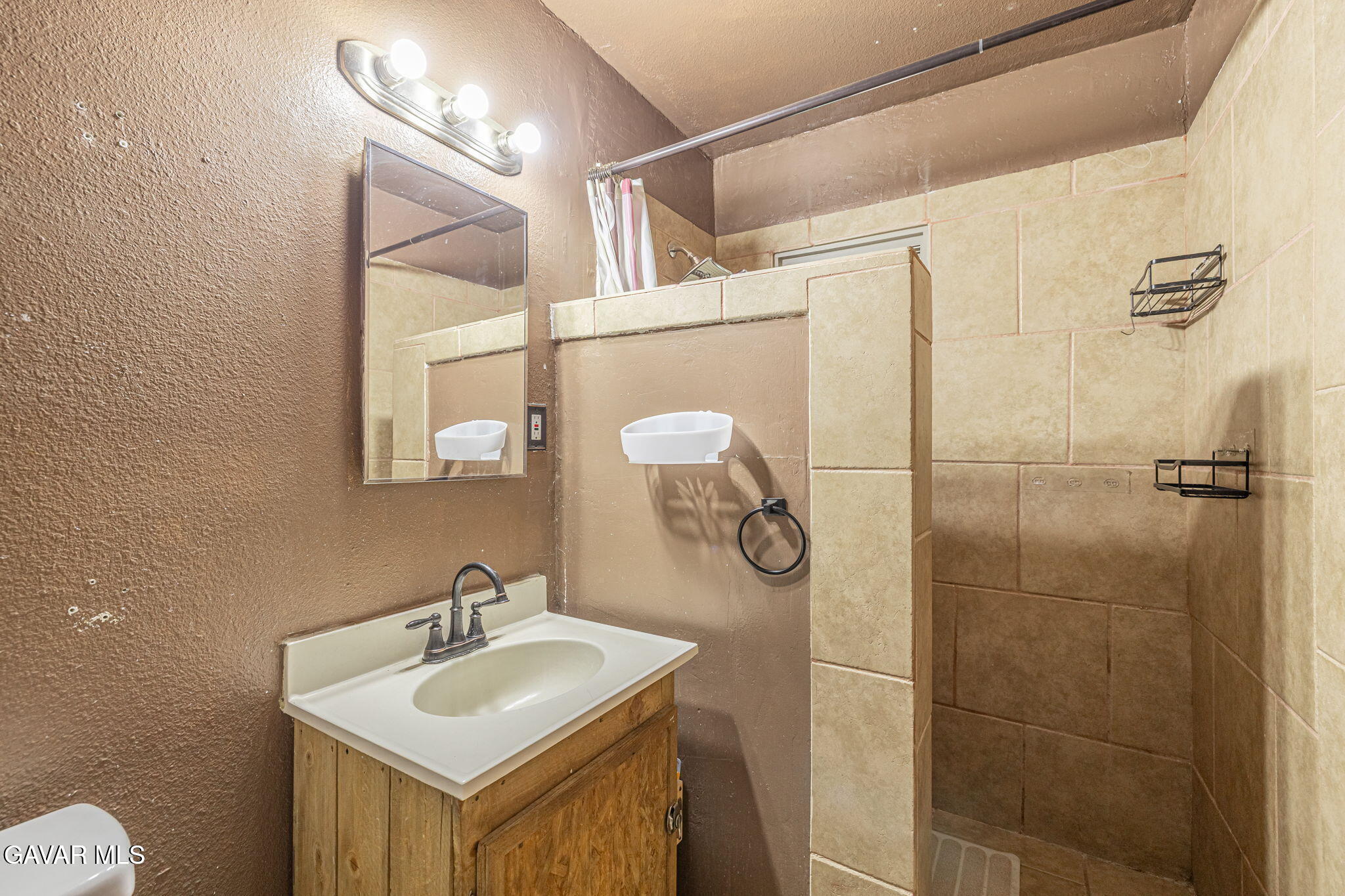 1342 Ave H 15 Lancaster, CA 93534 - Photo 12 of 15 a bathroom with a sink and mirror