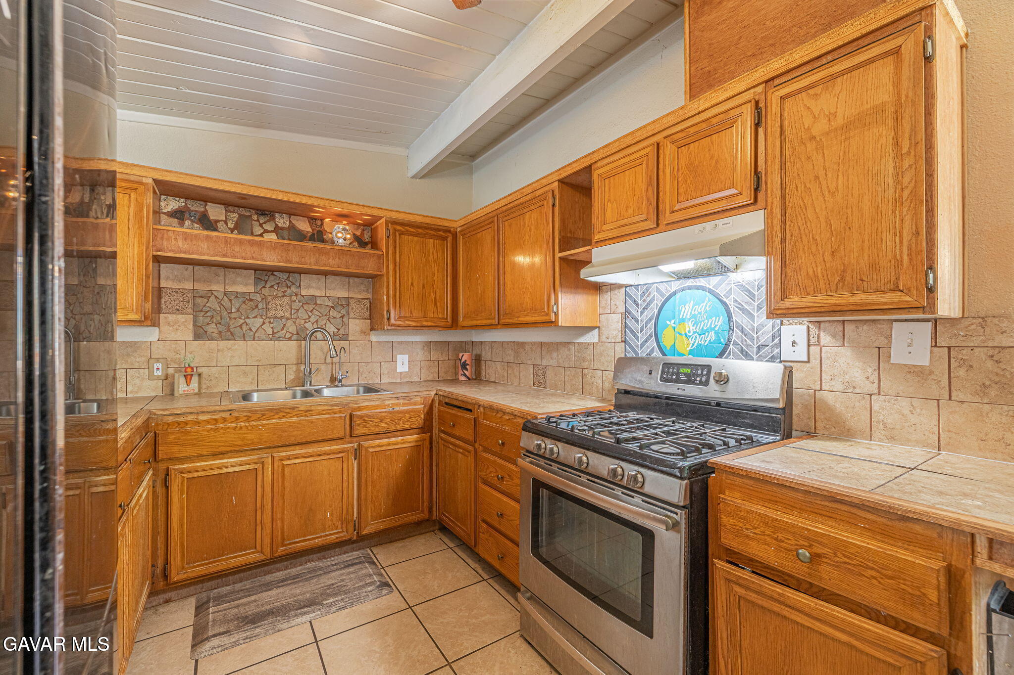 1342 Ave H 15 Lancaster, CA 93534 - Photo 6 of 15 a kitchen with a sink a stove cabinets and counter space