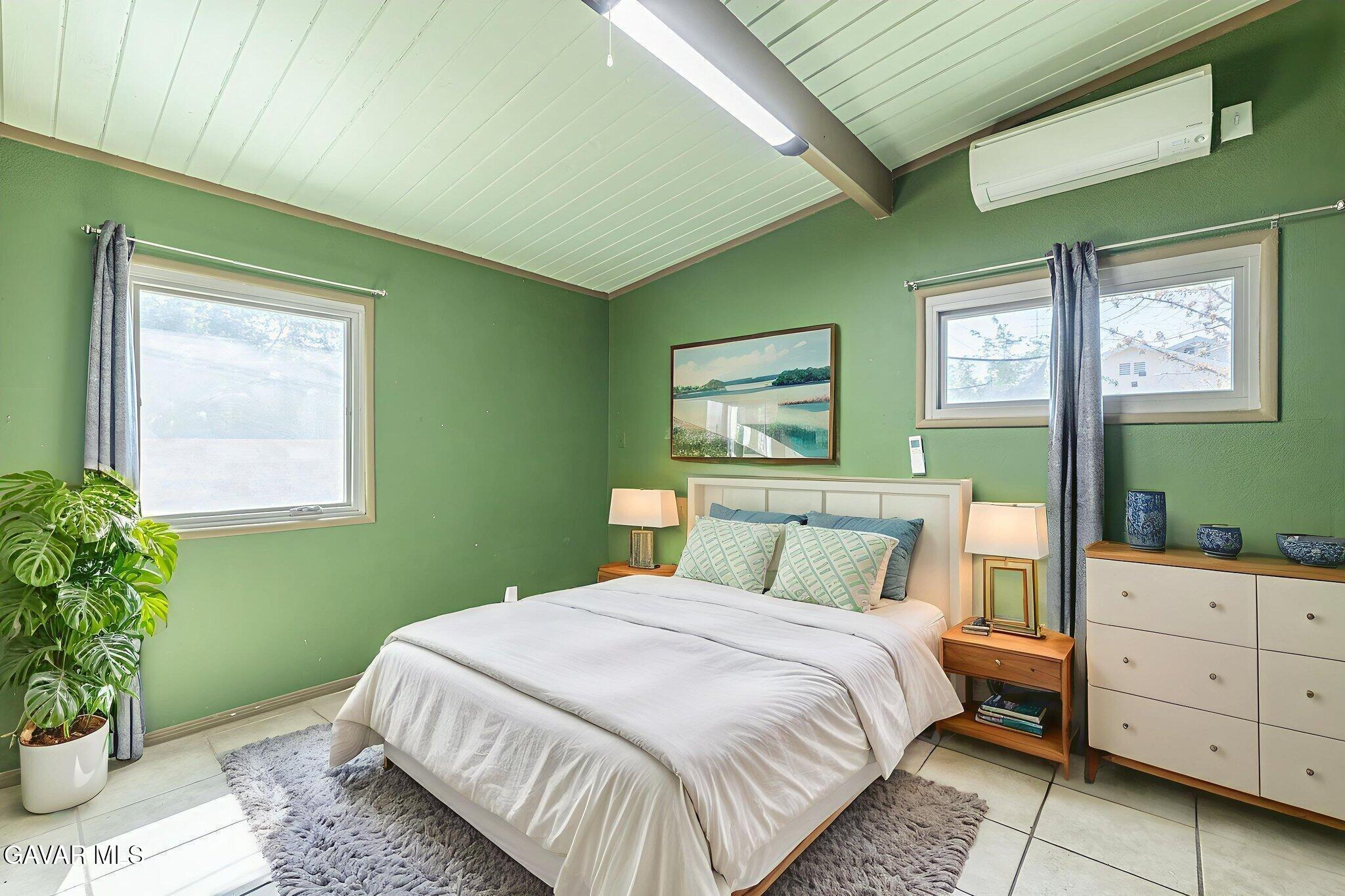 1342 Ave H 15 Lancaster, CA 93534 - Photo 10 of 15 a bedroom with a bed and a potted plant