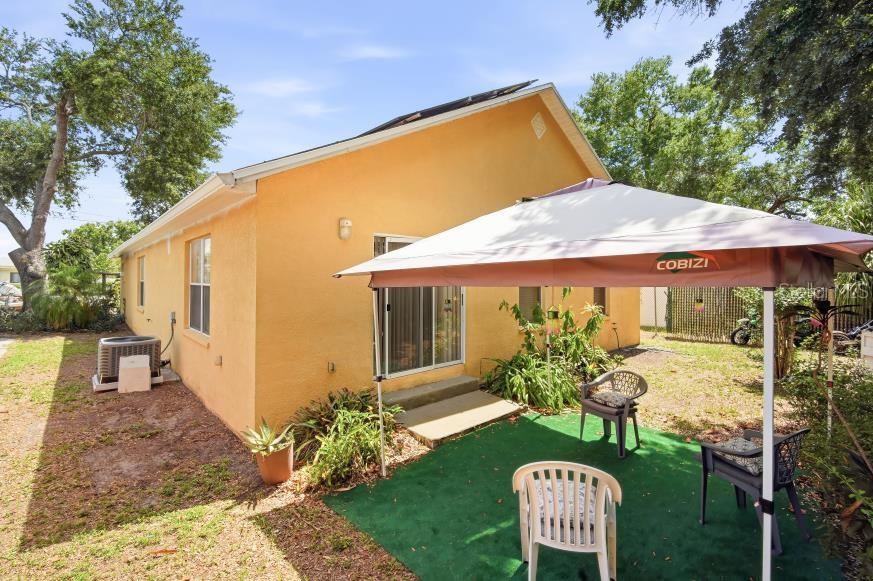 3005 West Chestnut Street Tampa, FL 33607 - Photo 21 of 27 a view of a chair and table in the backyard of the house