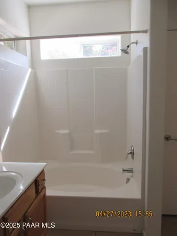 a bathroom with a shower and a bath tub