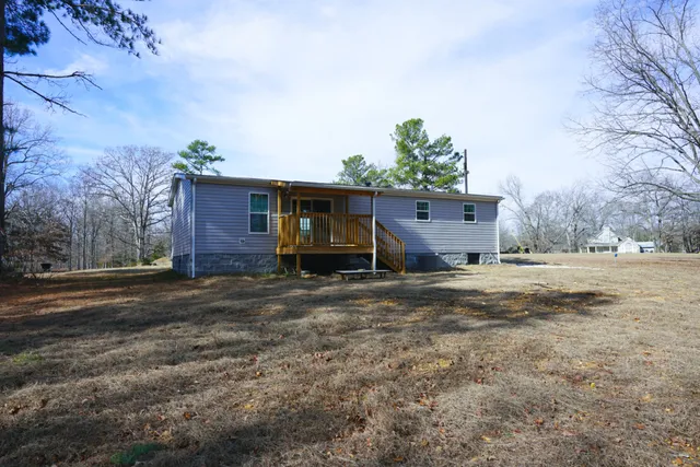 a living room with furniture a window and a flat screen tv