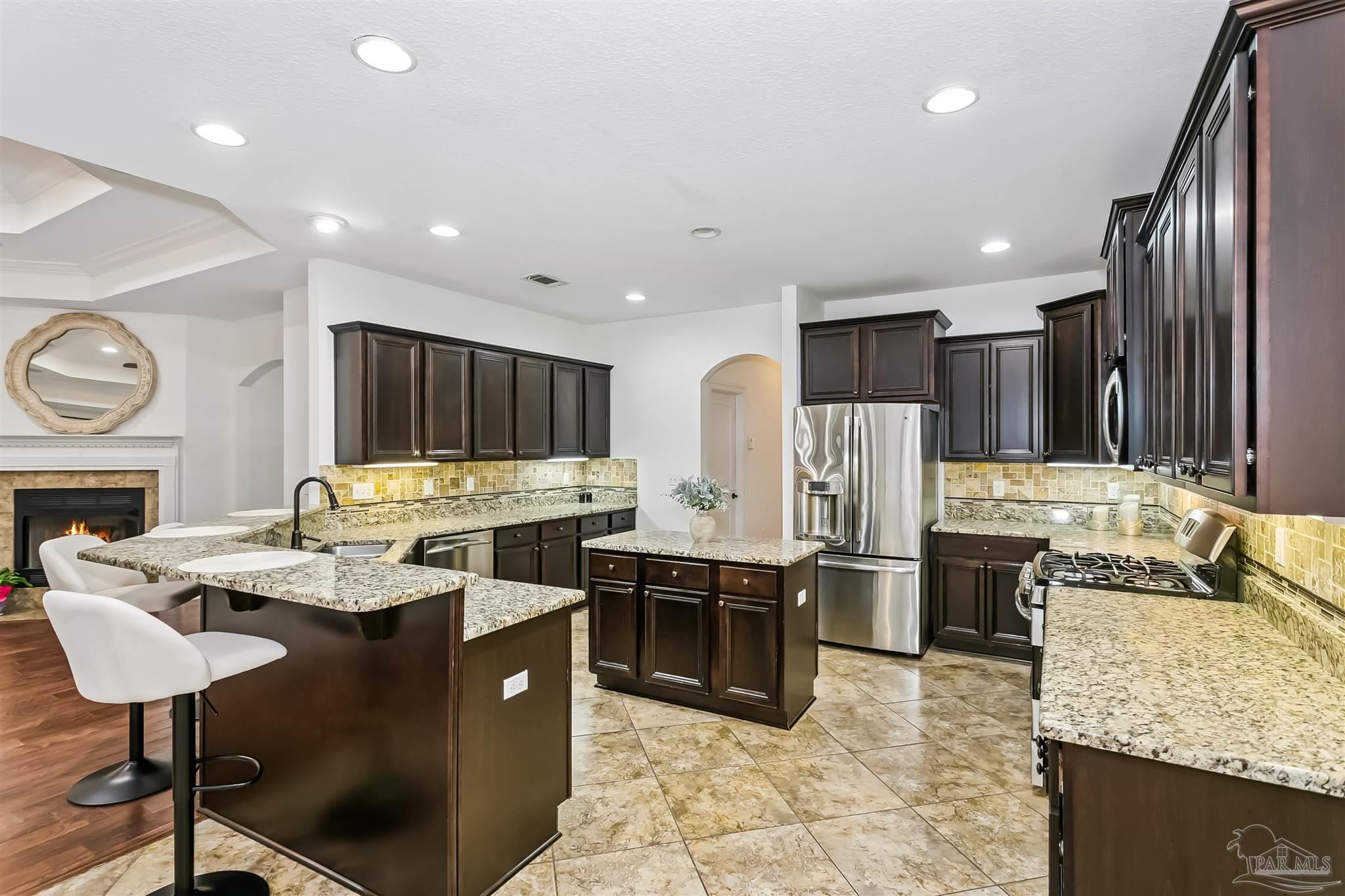 8414 Foxtail Loop Pensacola, FL 32526 - Photo 11 of 22 a kitchen with stainless steel appliances granite countertop a sink counter space and cabinets