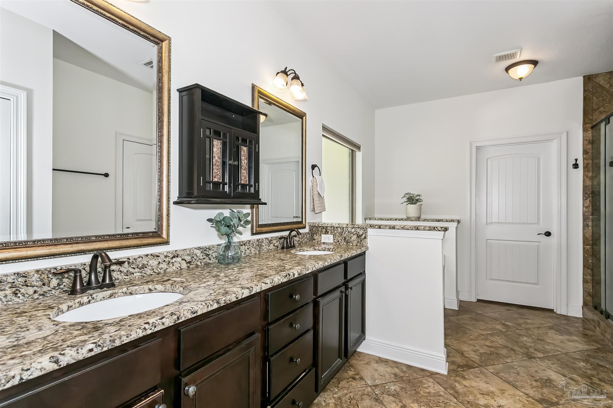 8414 Foxtail Loop Pensacola, FL 32526 - Photo 15 of 22 a bathroom with a granite countertop sink and a mirror