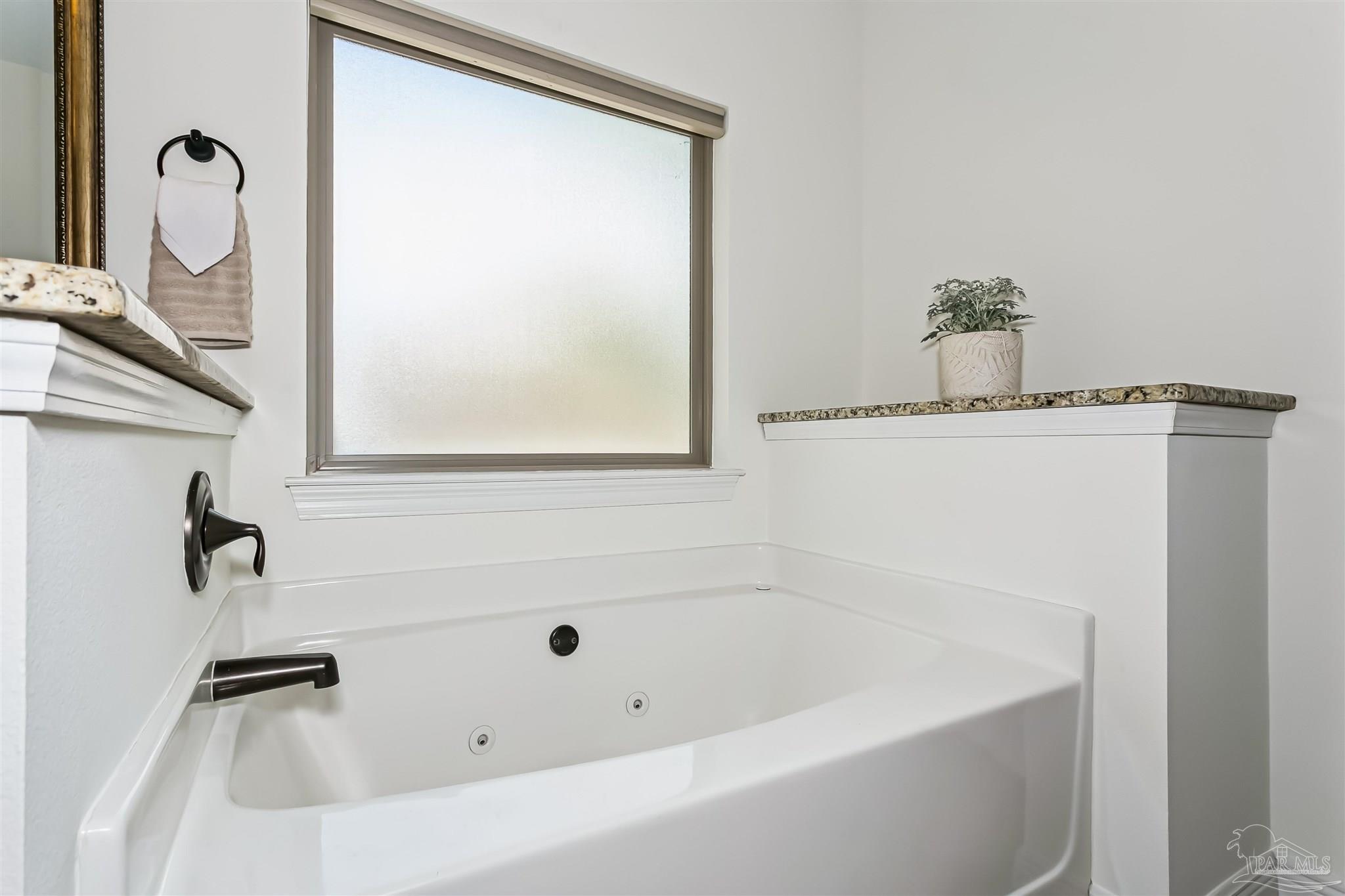 8414 Foxtail Loop Pensacola, FL 32526 - Photo 16 of 22 a bathroom with a tub and mirror