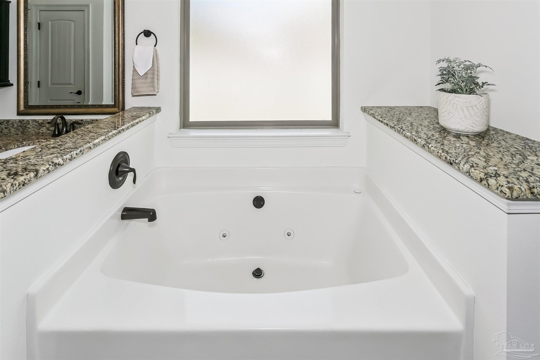 8414 Foxtail Loop Pensacola, FL 32526 - Photo 17 of 22 a bathroom with a tub sink and mirror