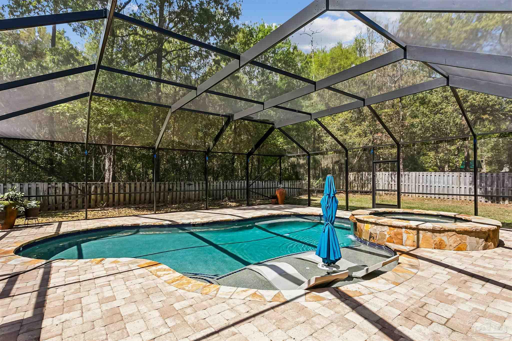 8414 Foxtail Loop Pensacola, FL 32526 - Photo 18 of 22 a view of a swimming pool with a patio and yard