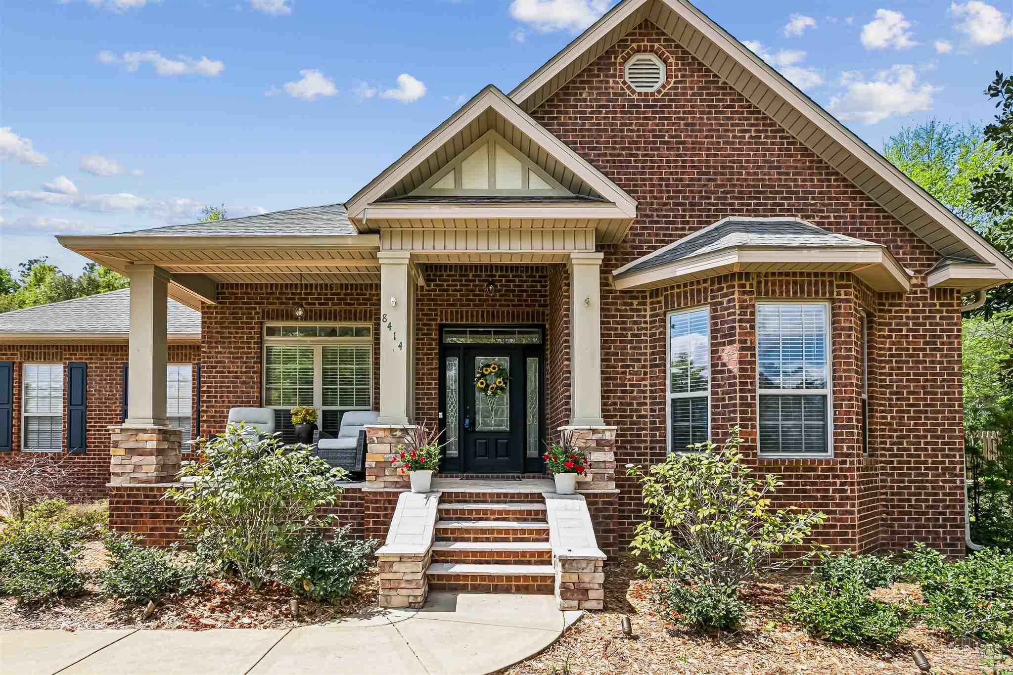 8414 Foxtail Loop Pensacola, FL 32526 - Photo 2 of 22 a front view of a house with a yard