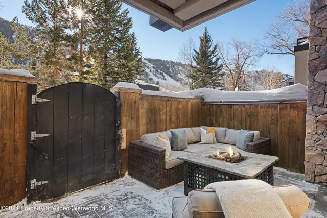 a backyard of a house with table and chairs