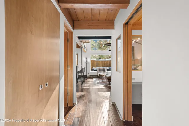 a view of a living room hardwood floor and a large window