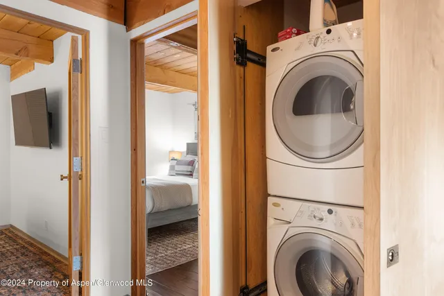 a view of a hallway with washer and dryer