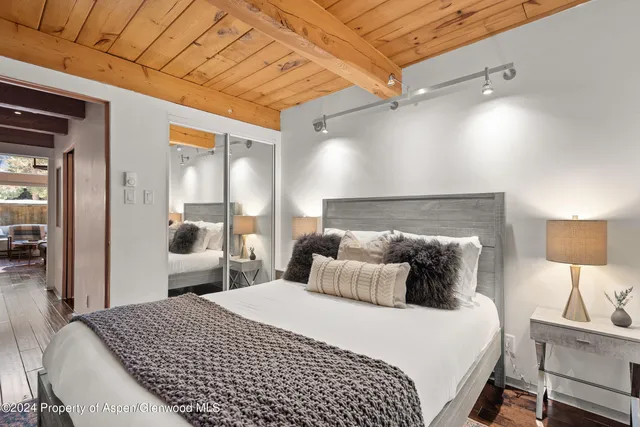 a bedroom with a bed and a lamp