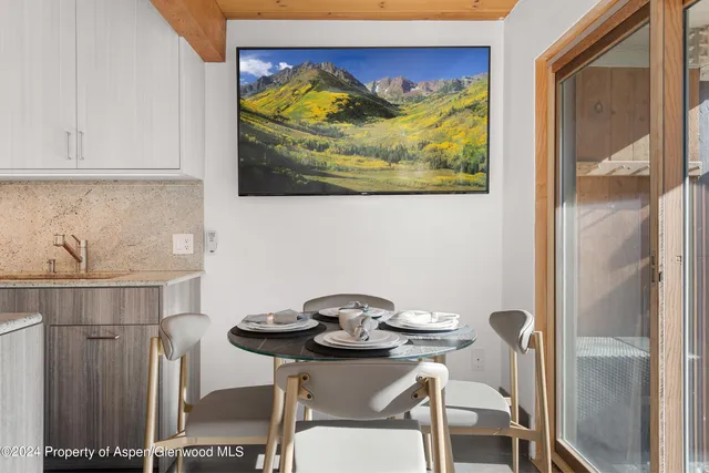 a view of a dining area with furniture and wooden floor