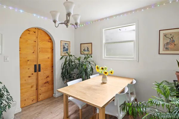a view of a dining room with a table and chairs