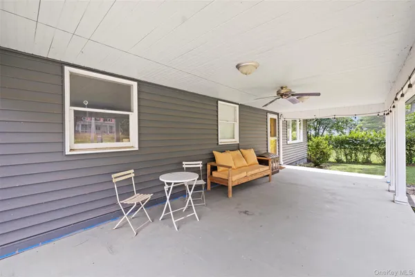 a backyard of a house with yard and outdoor seating