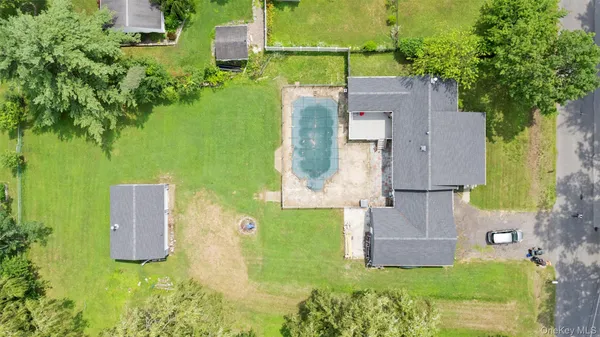 an aerial view of a house with a garden and trees