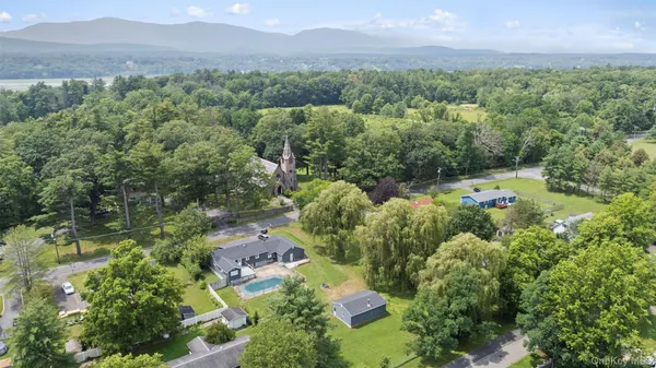 an aerial view of a city with lots of residential buildings and mountain view in back