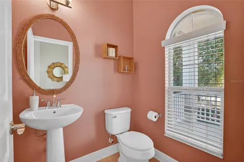 a bathroom with a toilet sink and mirror