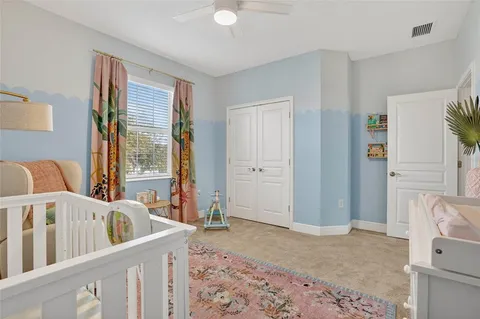 a view of a bedroom with furniture and windows