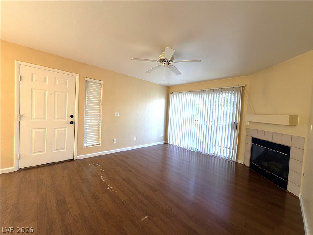4955 South Lindell Road, Unit 203 Las Vegas, NV 89118 - Photo 7 of 31 Hardwood floors and a cozy corner fireplace define this inviting living space.