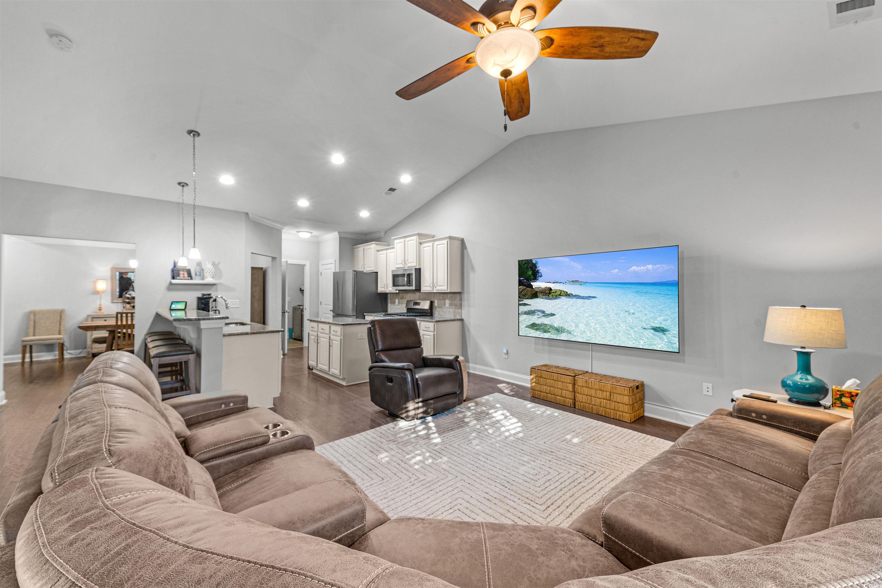 136 Parmelee Drive, Unit C Murrells Inlet, SC 29576 - Photo 12 of 40 Living area with lofted ceiling, dark wood-style floors, a ceiling fan, and recessed lighting