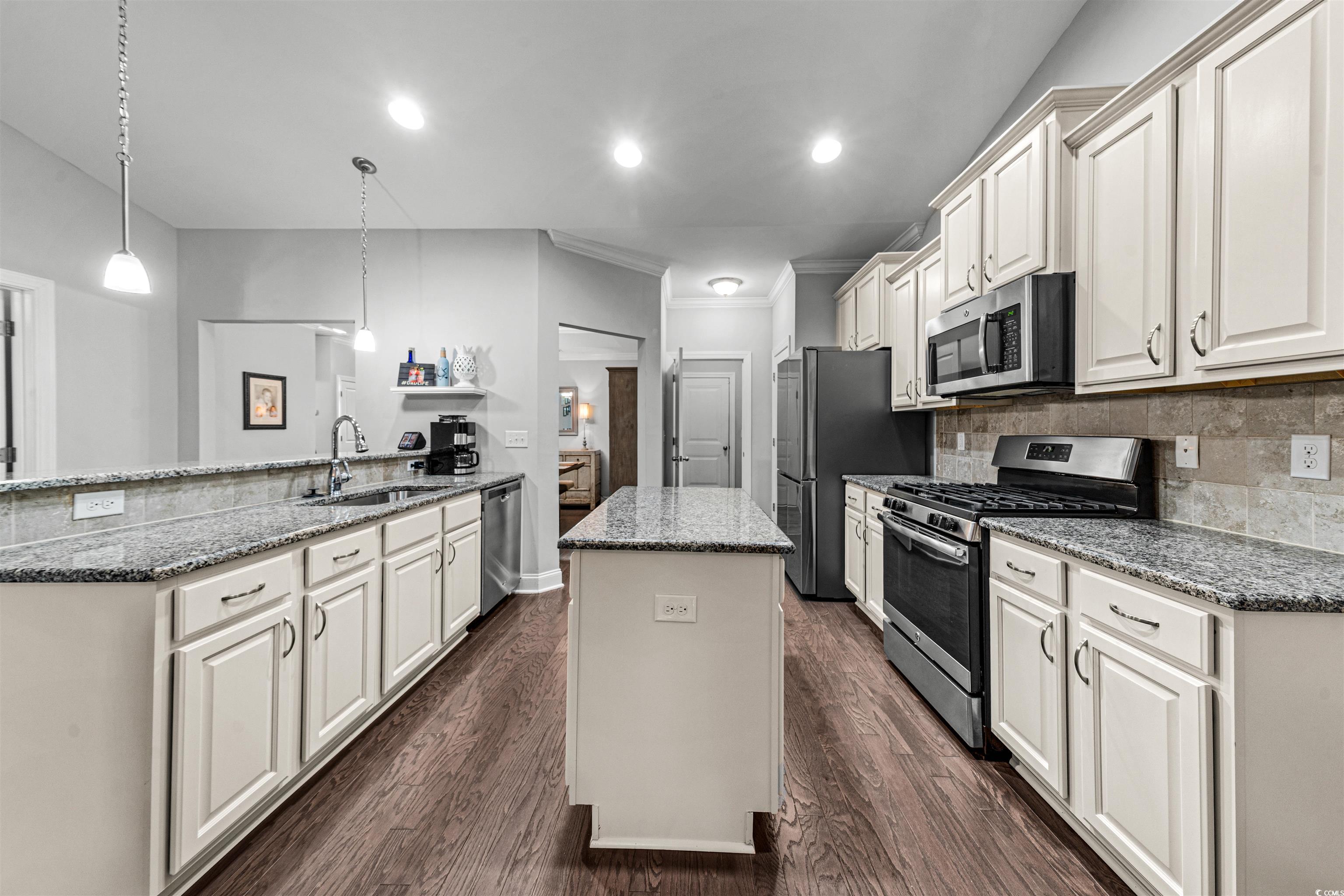 136 Parmelee Drive, Unit C Murrells Inlet, SC 29576 - Photo 15 of 40 Kitchen with stainless steel appliances, dark stone countertops, pendant lighting, a center island, and dark wood-style flooring