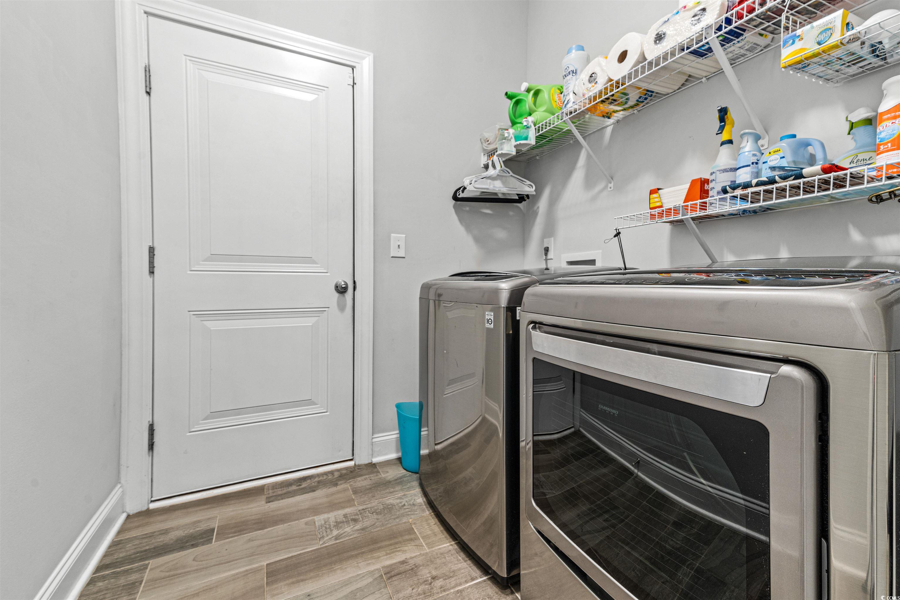 136 Parmelee Drive, Unit C Murrells Inlet, SC 29576 - Photo 18 of 40 Laundry room featuring wood tiled floors and washing machine and dryer