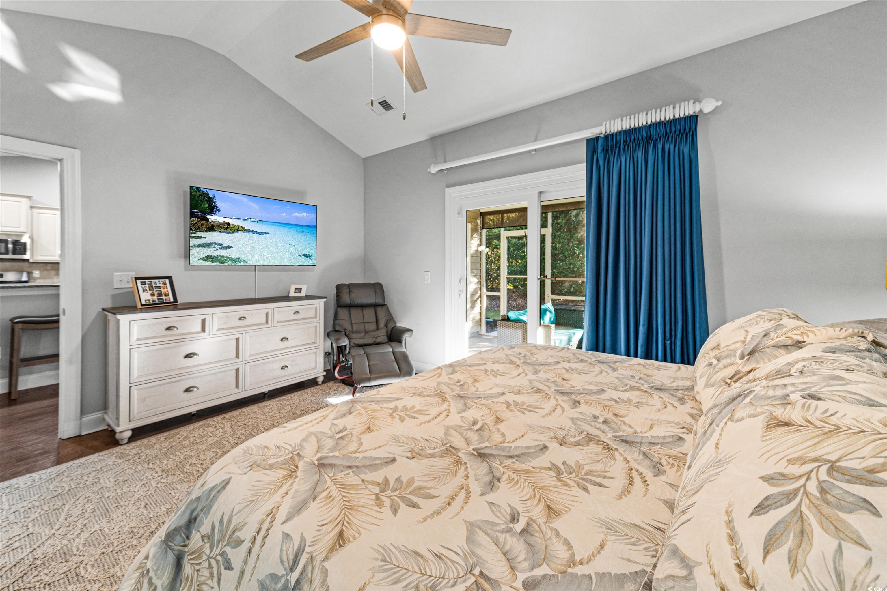 136 Parmelee Drive, Unit C Murrells Inlet, SC 29576 - Photo 22 of 40 Bedroom with lofted ceiling, a ceiling fan, access to outside, and ensuite bathroom